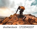 Success woman hiker hiking on sunrise mountain peak - Young woman with backpack rise to the mountain top. Discovery Travel Destination Concept
