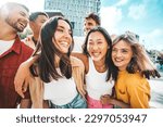 Small photo of Multiethnic friends having fun walking on city street - Group of young people enjoying summer vacation together - Friendship concept with guys and girls hanging outside on a sunny day