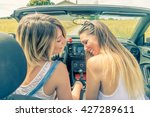 Young girls having fun at car trip - Two caucasian friends smiling outdoor in a summertime - Main focus on them 