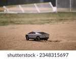 Small photo of Philadelphia, PA, USA - 672023; RC toy Cybertruck stirs dust on a baseball infield, its aimless path a reflection of uncertainty, a metaphor resonating amidst Elon Musk's ongoing economic challenges