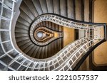 Abstract top down view of historical staircase curling through several floors, Prague, Czechia