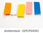 Small photo of Colored plasticine on a white background. Children's plasticine. Pieces of plasticine.
