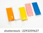 Small photo of Colored plasticine on a white background. Children's plasticine. Pieces of plasticine.