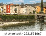 Small photo of Valeggio, Italy - 03-02-2022: The beautiful colored houses of the hamlet of Borghetto sul Mincio reflecting on the water