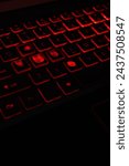 Small photo of Gamer's battleground: worn keys on a backlit keyboard reveal countless hours of passionate play. Intense gaming sessions highlighted by faded letters on a vibrant red-lit mechanical keyboard.