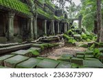 Small photo of Moss-covered stone building and bricks at Ta Prohm Tomb Raider temple. Angkor Wat, Siem Reap, Cambodia