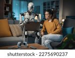 In the living room, a young woman and her humanoid robot companion use a laptop to learn, showcasing the potential of AI.