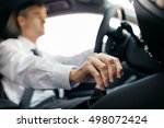 Businessman driving to work, hand shifting the gear stick