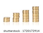 Gold coins stacked on a white background. Concept of saving money, economy, investment, growing business and wealth.