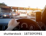The driver's hand is going up the motorway at the time of rush hour to go to work in the morning, driving pictures for background use. concept of commuting to work by car. travel, expressway, motorway