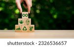 Small photo of circular economy icons in wooden cubes. economic system that aims to minimize waste and maximize resource efficiency, sustainable strategies to eliminate waste and pollution for future business growth