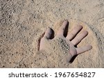 A Man's Hand Buried In An...
