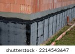 Small photo of rolls of black asphalt cardboard built side by side. warehouse for roof and home insulators who perform welding with propane gas burner on a clean penetration hardened surface