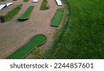 Small photo of minigolf course in park catch golf balls behind obstacle. game for points below par or above par, retirement house, senior, pay, game, tourist, beach, sand, resort, hotel, apartment, circle