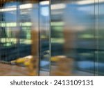 Small photo of transport rack for glass plates. glazing of buildings with new tempered glass with stripes pattern. the crossbar distorts the light and creates abstract images with an indeterminate blur.
