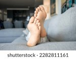 Close up of boy foot lying on floor at home