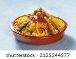 Meat and vegetable couscous in a bowl, typical food from Morocco, a traditional festive Arabic dish with herbs and spices