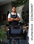 Small photo of Employment opportunities. Latin American barber in his own business. Young entrepreneur at his work. Happy Colombian stylist at his barbershop. Passionate person who enjoys what he does for a living.