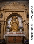 Small photo of Dornes PORTUGAL - 12 June 2020 - Stonework altar with evangelist niches and golden tabernacle in the center in lowlight