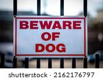 Small photo of Beware of Dog Sign on Fence