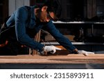 Small photo of Asian carpenter craftsman making pool cue or snooker cue with a manual hand wood planer in carpentry workplace in an old wooden shed. Handmade craftsman concept.