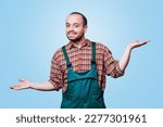 Small photo of expressive workman in a coverall is captured in a moment of pure, unadulterated happiness, his laughing expression and outstretched hands conveying a sense of joy and delight. copy space, studio shot