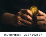 cryptocurrency golden bitcion. hand holding gold bitcoin - virtual Btc neon sign for trading web  and international network payment. 
