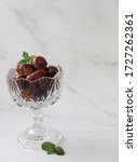 Small photo of Dates fruits in the glass jar with white background. Negatif space. selective focus