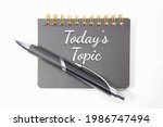 pen, notebook with today’s topic words and white background