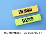 Small photo of two colored papers with the words breakout sessions