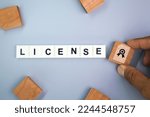Small photo of letters of the alphabet with the word license. concept of licensing law. driving license. business license