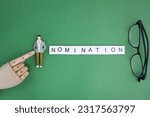 Small photo of letters of the alphabet with the word nomination. the concept of nomination or being nominated