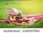 Picnic basket with fruit and...