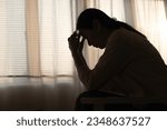 Small photo of Female having depression sitting alone in bedroom dark corner. woman headache unhappy emotion. young anxiety despairing mental health problems. Dark Tone.