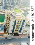 Small photo of Dubai, UAE - May 29, 2019: It is view of Dubai Marina and rooftop of building apartment on promenade. It is Perl Marina hotel.