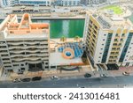 Small photo of Dubai, UAE - May 29, 2019: It is view of Dubai Marina and rooftop of building apartment on a promenade. It is Falcon hotel. It is Perl Marina hotel.