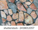 Small photo of It is colorful stone wall of European house. This is stone wall texture. It is multicolored view of a stone floor. it is stone background. It is view color stones. It is close up view of the stones