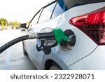 Green gas pump for refueling car on gas station.Green fuel, gasoline dispenser in station.The driver refuel at the petrol station.Save energy concept.