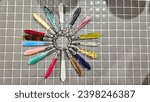Small photo of Bright abstract picture, beautiful mother of pearl nacreous handles on a ring, arranged in a circle on small mazaik tiles