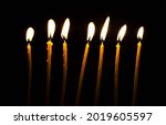 Seven Thin Candles Burning In...