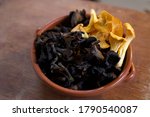                 local foraged wild chanterelle and black trumpet mushrooms in terra cotta casuela bowl               