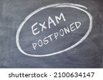 Small photo of EXAM postponed text on blackboard background.