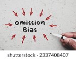 Small photo of Man hand pointing out Omission Bias inscription on concrete background. Negative decision to harmful actions concept.