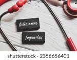 Small photo of Nitrosamine Impurities inscription on wooden chips with stethoscopes on white background. Nitrosamine Impurities in certain drugs and pharmaceutical products concept.