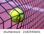 CLOSEUP OF A TENNIS OR PADEL BALL HITTING THE NET. SPORT BETS IN BETTING SHOPS.
