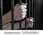 Small photo of Prisoner's hands gripping the bars of a cell in jail or prison serving sentence.