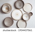 handmade ceramics, empty craft ceramic plates on light background top view