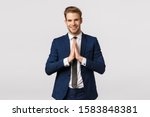 Namaste. Handsome young caucasian businessman greeting asian business partners, hold hands together in pray, supplicating or greeting gesture, smiling friendly, standing white background