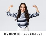 Small photo of Lifestyle, people emotions and casual concept. Strong and confident asian woman flex biceps, bragging her perfect shape after sign-up gym membership, brag with muscles, workout and feeling strong