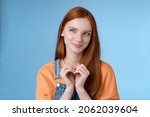 Small photo of Devious tricky young girl have excellent plan smirking delighted mysteriously look upper left corner smiling have idea thoughtfully twiddles fingers standing rejoicing blue background
